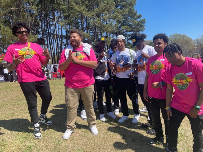 Pine Forest High School students who are part of the Two-Six Project's emerging leaders program, in white shirts, with Dreamville Festival ambassadors at Dorothea Dix Park in Raleigh on Saturday, April 2, 2022