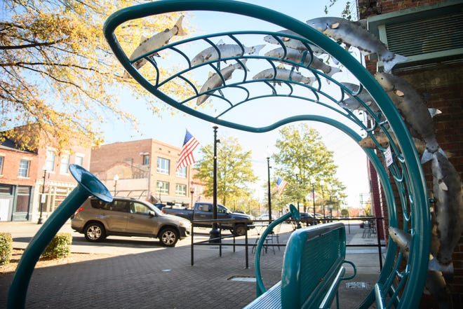 “Salmon Run Whisper Bench” by Jim Gallucci is located on the 100 block of Person St.