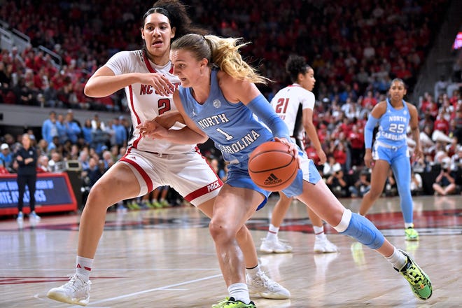 North Carolina's Alyssa Ustby (1) drives to the basket against N.C State's Mimi Collins (2) during the first half. The N.C. State Wolfpack and the North Carolina Tar Heels met in a regular-season game in Raleigh, N.C., on Feb. 1, 2024.