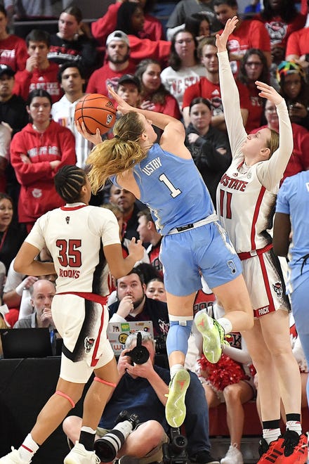 North Carolina's Alyssa Ustlby (1) shoots against N.C State's Maddie Cox (11) during the second half. The N.C. State Wolfpack and the North Carolina Tar Heels met in a regular-season game in Raleigh, N.C., on Feb. 1, 2024.