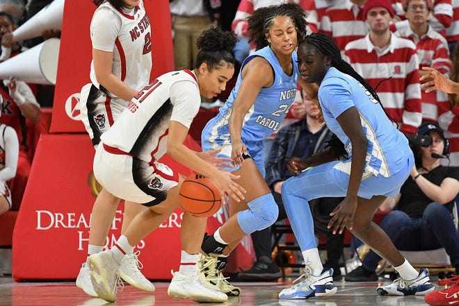 N.C State's Madison Hayes (21) gets the loose ball against North Carolina during the second half. The N.C. State Wolfpack and the North Carolina Tar Heels met in a regular-season game in Raleigh, N.C., on Feb. 1, 2024.
