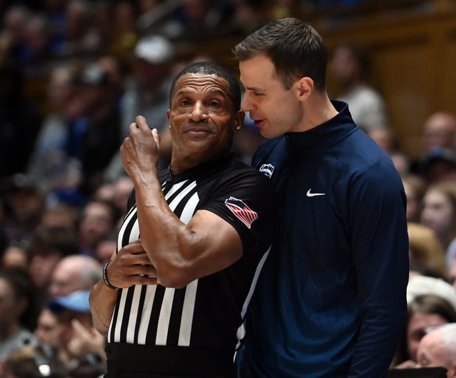 Feb 12, 2024; Durham, North Carolina, USA; Duke Blue Devils head coach Jon Scheyer (right) talks with referee Ted Valentine during the first half of a game against the Wake Forest Deamon Deacons at Cameron Indoor Stadium. Mandatory Credit: Rob Kinnan-USA TODAY Sports