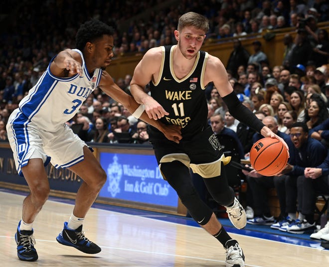 Feb 12, 2024; Durham, North Carolina, USA; Wake Forest Deamon Deacons forward Andrew Carr (11) drives to the basket as Duke Blue Devils forward Sean Stewart (13) defends during the first half at Cameron Indoor Stadium. Mandatory Credit: Rob Kinnan-USA TODAY Sports