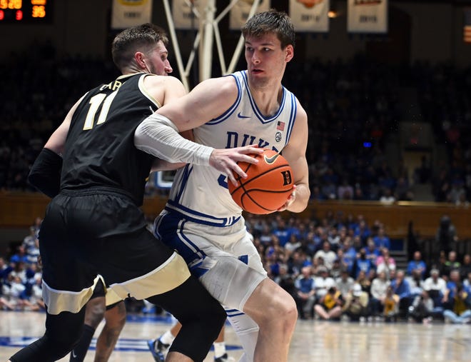 Feb 12, 2024; Durham, North Carolina, USA; Duke Blue Devils center Kyle Filipowski (30) spins to the basket as Wake Forest Deamon Deacons forward Andrew Carr (11) defends during the second half at Cameron Indoor Stadium. The Blue Devils won 77-69. Mandatory Credit: Rob Kinnan-USA TODAY Sports