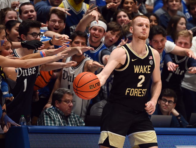 Feb 12, 2024; Durham, North Carolina, USA; Duke Blue Devils fans harass Wake Forest Deamon Deacons guard Cameron Hildreth (2) as he inbounds the ball during the second half at Cameron Indoor Stadium. The Blue Devils won 77-69. Mandatory Credit: Rob Kinnan-USA TODAY Sports