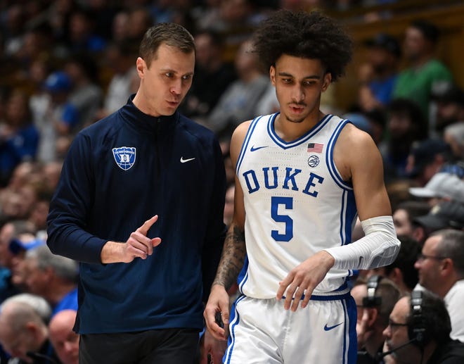 Feb 12, 2024; Durham, North Carolina, USA; Duke Blue Devils head coach Jon Scheyer (left) talks to guard Tyrese Proctor (5) during the second half against the Wake Forest Deamon Deacons at Cameron Indoor Stadium. The Blue Devils won 77-69. Mandatory Credit: Rob Kinnan-USA TODAY Sports
