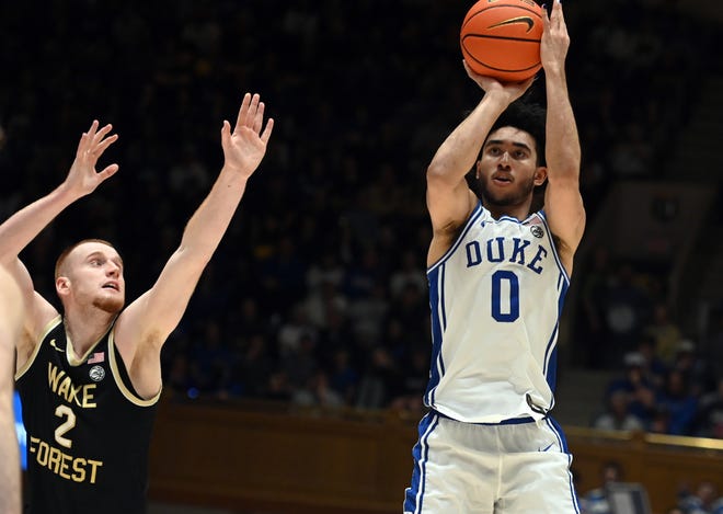 Feb 12, 2024; Durham, North Carolina, USA; Duke Blue Devils guard Jared McCain (0) shoots in front of Wake Forest Deamon Deacons guard Cameron Hildreth (2) during the second half at Cameron Indoor Stadium. The Blue Devils won 77-69. Mandatory Credit: Rob Kinnan-USA TODAY Sports