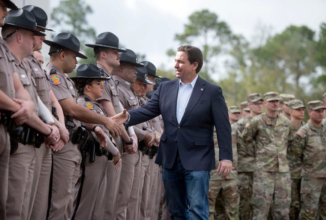 February 23, 2024: Florida Governor Ron DeSantis greets Florida State Troopers and National Guard members during a press conference in Pensacola, Florida. The governor was in Pensacola to announce the deployment of Florida Highway Patrol and the Guard to Texas to help secure its southern border.