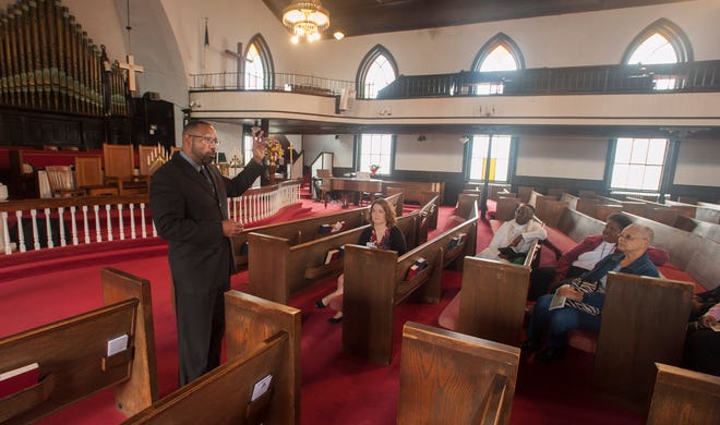 Rev. Corey Little, pastor of Evans Metropolitan AME Zion Church, speaks to participants on a bus tour of Fayetteville historic sites associated with Edward and Sallie Evans Monday, Feb. 22, 2016.