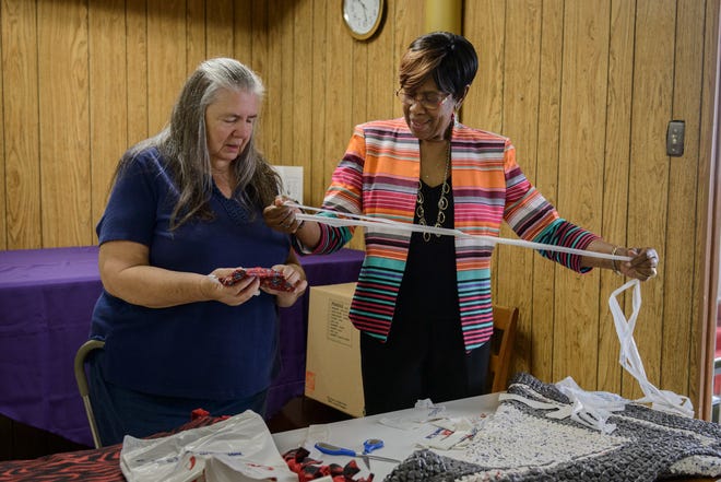 Beulah McKay, at right, explains to Dee Boyer how to crochet a blanket from plastic grocery store bags. They were at the knitting and crochet class at Evans Metropolitan AME Zion Church in Fayetteville on Monday, Oct. 3, 2016.