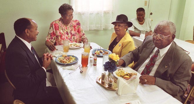 Jimmy Morrow, Maye Walker, Evelyn Durham and Paul Lewis enjoy their meal during the supper at Mt. Sinai Baptist Church, Sunday, Aug. 19, 2001.