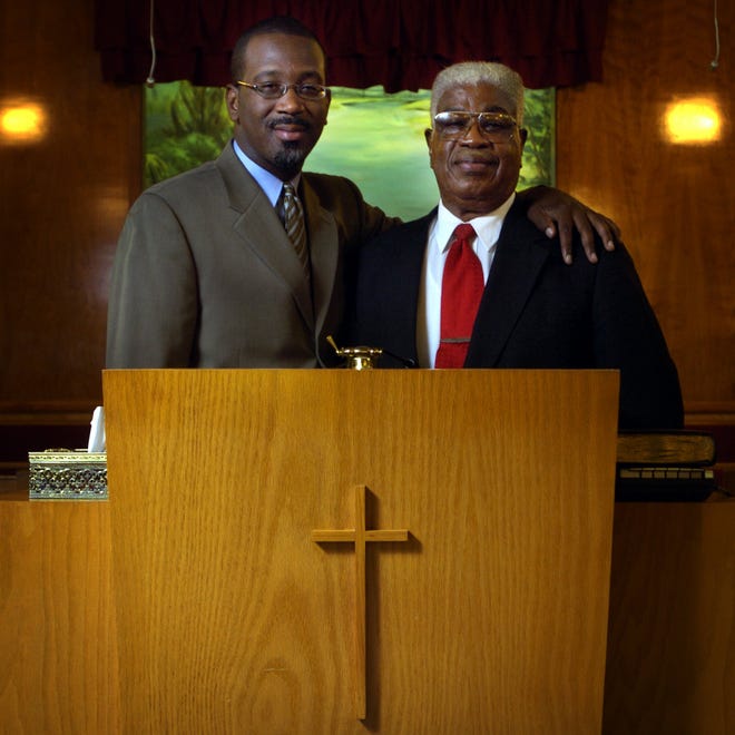 Dr. Aaron Johnson (right) and his son, Jamale, in 2005. The two are pastors at Mount Sinai Baptist Church on Murchison Road.