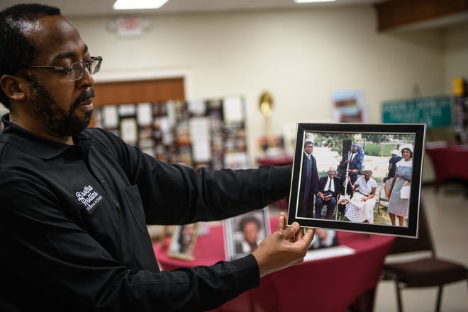 Louis Rollins holds up a photograph from a groundbreaking at the Mt. Sinai Missionary Baptist Church. The church has a rich history and a museum that explains it all.