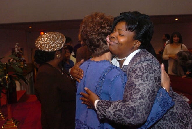 Lonobia Keys greets Nettie Washington Douglass after the 11 a.m. worship service Sunday at Lewis Chapel Missionary Baptist Church on Feb. 20, 2005. Members of the church lined the front of the sanctuary after the service to thank Douglass for her message and a few even got autographs.