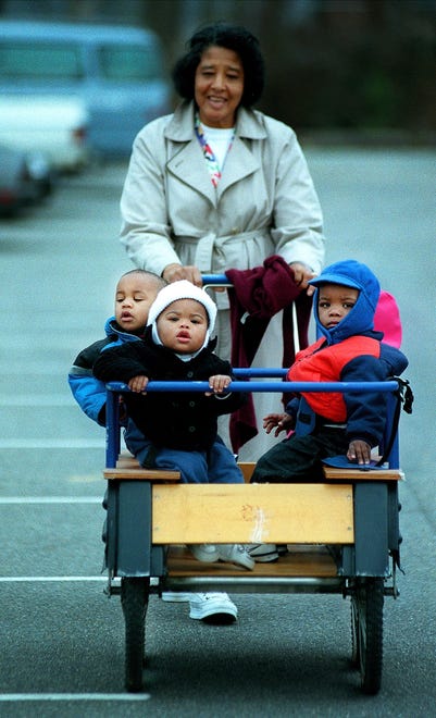 Helen Schofield, back, pushes little ones on the unusually warm day Thursday, Feb. 14, 2000, in the Lewis Chapel Baptist Church Day Care parking lot. Schofield wanted to take advantage of the nice weather with Jared McCollums, 1, left, Austin Scales, 1, center, and Michael Rich, 7 mos., not pictured in background is Minah Ahmad, 7 mos.
