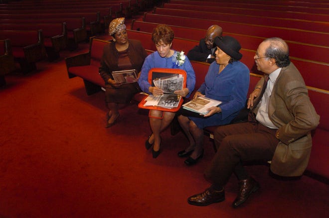 Nettie Washington Douglass, 2nd from left, shares some of her family pictures and keepsakes with Eloise E. Melvin, from left, Donald Byrd, Barbara Brooks and Ron Brooks Sunday at Lewis Chapel Missionary Baptist Church on Feb. 20, 2005. Douglass is the great-granddaughter of Booker T. Washington and the great-great-granddaughter of Frederick Douglass.