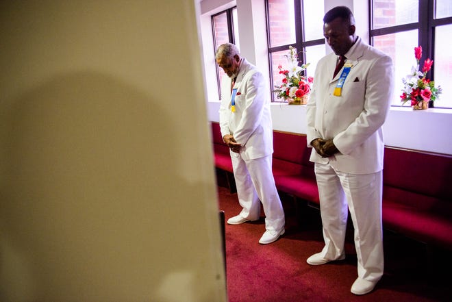 Ushers bow their heads during a prayer Sunday April 23, 2017 during the annual crowning of the Mother of the Year for the Fayetteville branch of the NAACP at Lewis Chapel Missionary Baptist Church.