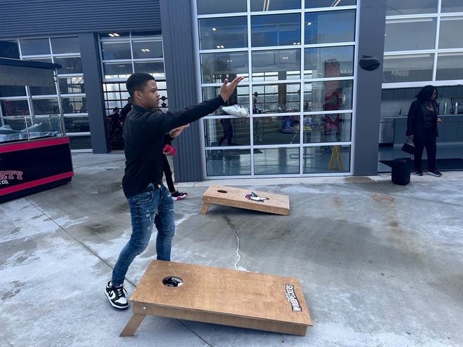 Jarious Parker, 16, playing cornhole with his mom, Renee Barnes, 54, at the 3rd annual It's a Family Affair Sneaker Ball even at Segra Stadium, Mar. 2, 2024.