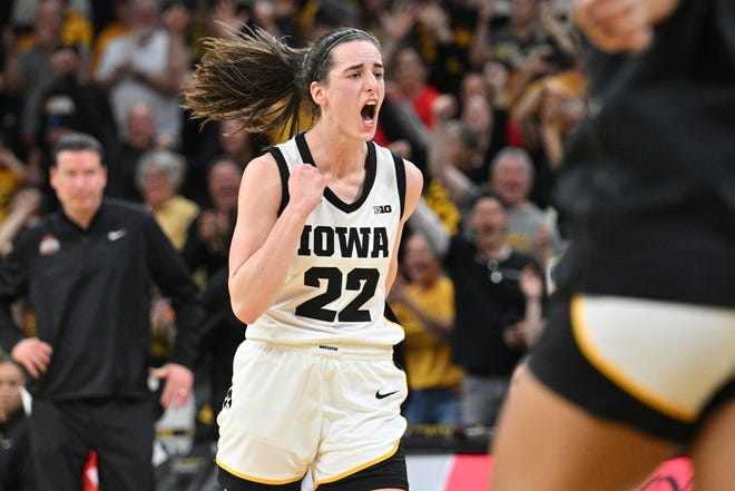 March 3, 2024 : Iowa Hawkeyes guard Caitlin Clark (22) reacts after breaking the NCAA basketball all-time scoring record during the second quarter against the Ohio State Buckeyes.
