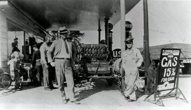 This 1900 "Holsman" stopped in Fayetteville to get gas on it's way north sometime during the 1930's. Keith George who submitted the photo is standing to the right and George Deese is at the left. George said the old man driving the car had come all the way from the west coast. The station where he stopped was on Raeford Road just beyond the Robeson St. intersection.
