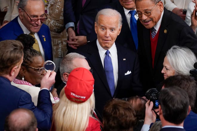 March 7, 2024: President Joe Biden reacts to seeing  Rep. Marjorie Taylor Greene while he arrives to deliver the State of the Union address to Congress at the U.S. Capitol in Washington.