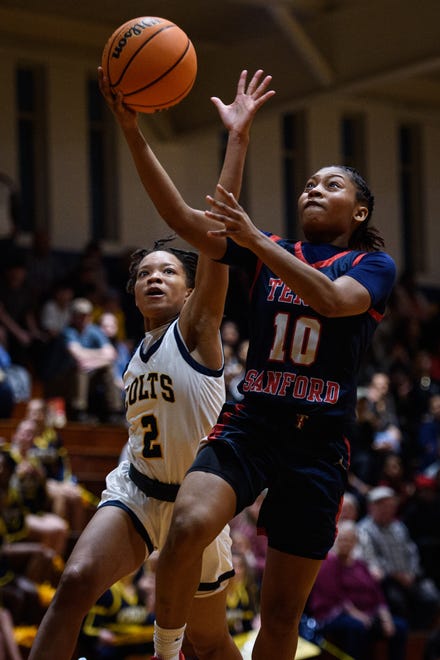 Terry Sanford’s Ameya Brown goes up for a shot with Cape Fear’s Anijah Jones tailing her during fourth round of 3A East playoff game on Friday, March 8, 2024.