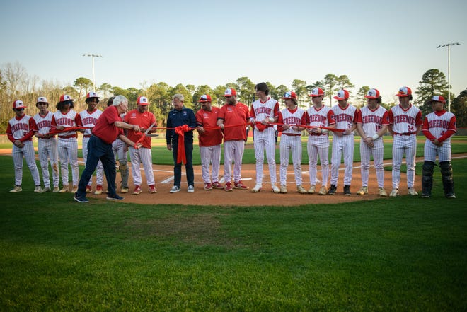 Freedom Christian Academy co-founder Hall Powers cuts the ribbon on the school’s new baseball field during a game against St. Pauls on Thursday, March 14, 2024.