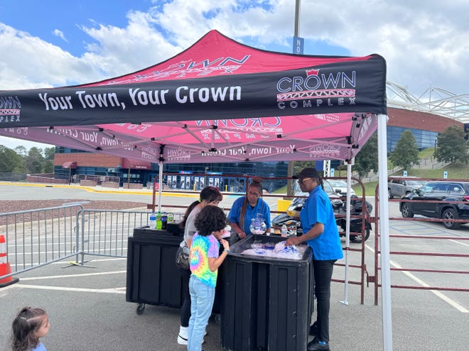 Crown Coliseum employees handing out drinks to thirsty Fayetteville Eats Food Festival attendees, March 16, 2024.