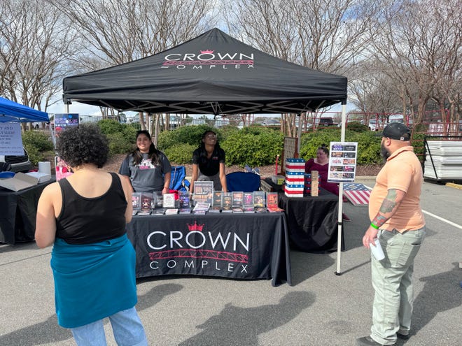 Crown Coliseum employees promoting future events at the complex at the Fayetteville Eats Food Festival, March 16, 2024.