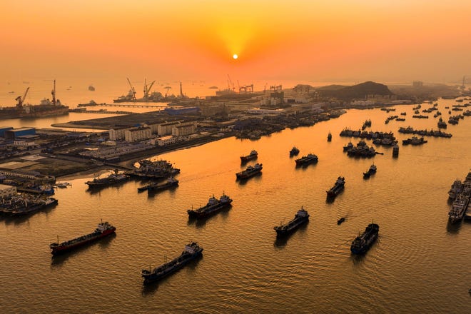 March 20, 2024: Fishing boats sailing around Shenjiamen Fishing Port during sunset in Zhoushan, in eastern China's Zhejiang province.