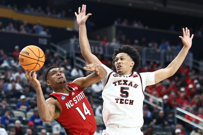 NC State's Casey Morsell shoots against Texas Tech's Darrion Williams during the first half in the first round of the NCAA Men's Basketball Tournament, Thursday, March 21, 2024, at PPG PAINTS Arena in Pittsburgh, Pennsylvania.