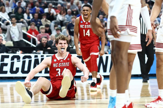 NC State's Ben Middlebrooks reacts with his teammate NC State's Casey Morsell during the first half of a game against the Texas Tech in the first round of the NCAA Men's Basketball Tournament, Thursday, March 21, 2024, at PPG PAINTS Arena in Pittsburgh, Pennsylvania.