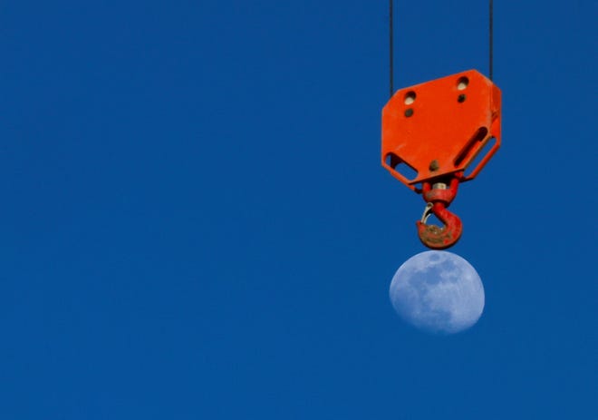 March 21, 2024: The moon rises behind a crane at a construction site in Rome, Italy March 21, 2024.