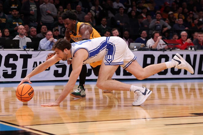 Mar 22, 2024; Brooklyn, NY, USA; Duke Blue Devils center Ryan Young (15) reaches for a loose ball past Vermont Catamounts guard Sam Alamutu (2) in the first round of the 2024 NCAA Tournament at the Barclays Center. Mandatory Credit: Brad Penner-USA TODAY Sports