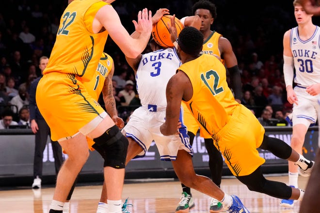 Mar 22, 2024; Brooklyn, NY, USA; Duke Blue Devils guard Jeremy Roach (3) attempts to shoot the ball over Vermont Catamounts forward Nick Fiorillo (32) and guard Shamir Bogues (12) in the first round of the 2024 NCAA Tournament at the Barclays Center. Mandatory Credit: Robert Deutsch-USA TODAY Sports