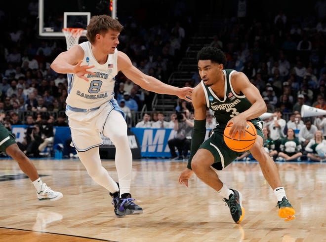 Michigan State Spartans guard Jaden Akins (3) dribbles against North Carolina Tar Heels guard Paxson Wojcik (8) in the second round of the 2024 NCAA Tournament on Saturday at the Spectrum Center in Charlotte, N.C.