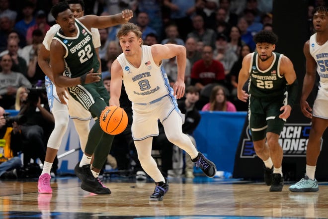 North Carolina Tar Heels guard Paxson Wojcik (8) controls the ball against the Michigan State Spartans in the second round of the 2024 NCAA Tournament on Saturday at the Spectrum Center in Charlotte, N.C.