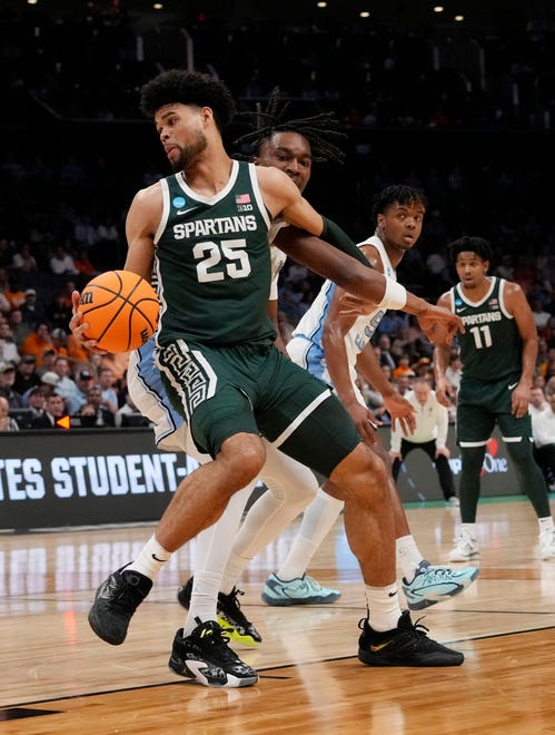 Michigan State Spartans forward Malik Hall (25) spins to the basket against the North Carolina Tar Heels in the second round of the 2024 NCAA Tournament on Saturday at the Spectrum Center in Charlotte, N.C.