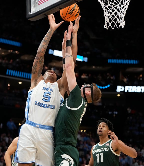 North Carolina Tar Heels forward Armando Bacot (5) battles for the ball with Michigan State Spartans center Carson Cooper (15) in the second round of the 2024 NCAA Tournament on Saturday at the Spectrum Center in Charlotte, N.C.