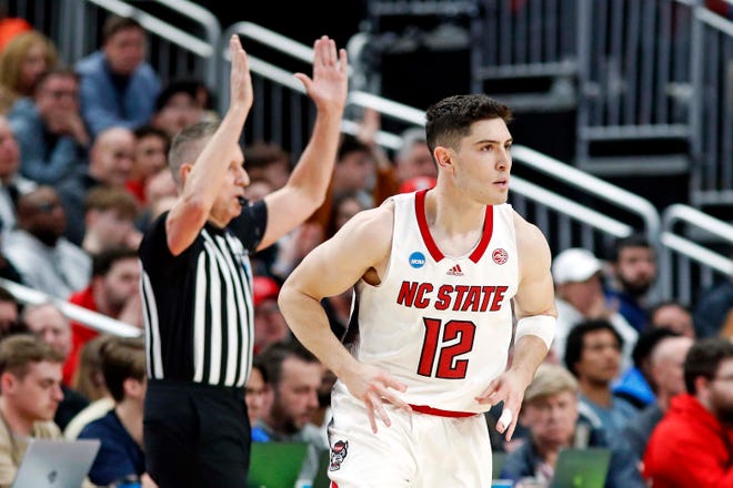 Mar 23, 2024; Pittsburgh, PA, USA; North Carolina State Wolfpack guard Michael O'Connell (12) celebrates after making a three pointer during the first half of the game against the Oakland Golden Grizzlies in the second round of the 2024 NCAA Tournament at PPG Paints Arena. Mandatory Credit: Charles LeClaire-USA TODAY Sports