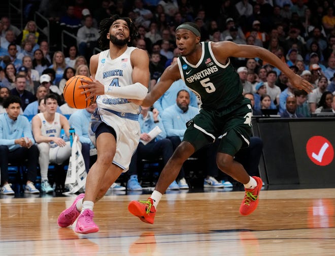 North Carolina Tar Heels guard RJ Davis (4) drives against Michigan State Spartans guard Tre Holloman (5) in the second round of the 2024 NCAA Tournament on Saturday at the Spectrum Center in Charlotte, N.C.