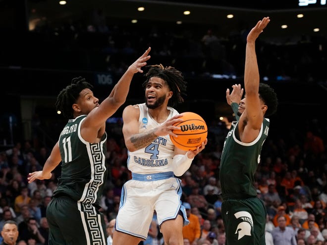 North Carolina Tar Heels guard RJ Davis (4) shoots against Michigan State Spartans guard A.J. Hoggard (11) in the second round of the 2024 NCAA Tournament on Saturday at the Spectrum Center in Charlotte, N.C.