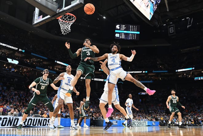 Michigan State Spartans guard Jaden Akins (3) and North Carolina Tar Heels guard RJ Davis (4) battle for a rebound in the second round of the 2024 NCAA Tournament on Saturday at the Spectrum Center in Charlotte, N.C.