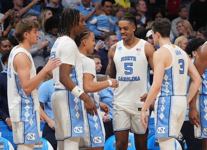 North Carolina Tar Heels forward Armando Bacot (5) celebrates with teammates against the Michigan State Spartans in the second round of the 2024 NCAA Tournament on Saturday at the Spectrum Center in Charlotte, N.C.
