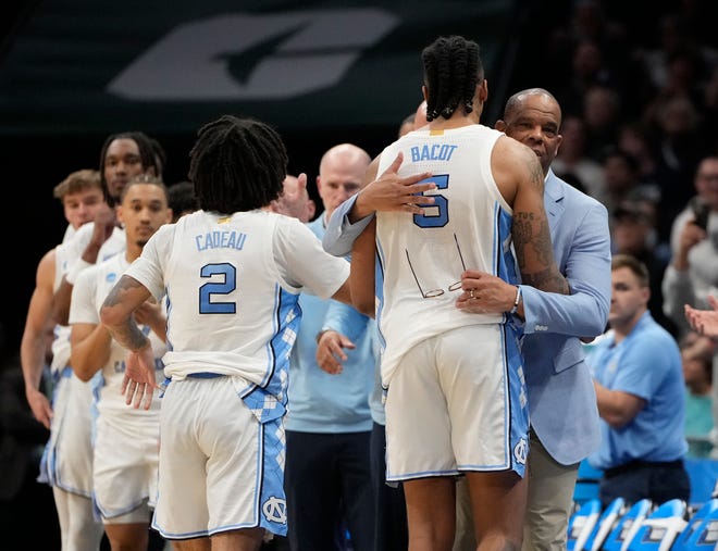 North Carolina Tar Heels head coach Hubert Davis greets forward Armando Bacot (5) in the second half against the Michigan State Spartans in the second round of the 2024 NCAA Tournament on Saturday at the Spectrum Center in Charlotte, N.C.