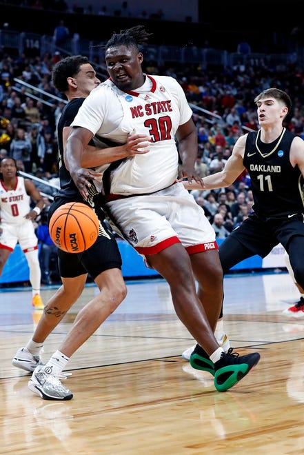 Mar 23, 2024; Pittsburgh, PA, USA; North Carolina State Wolfpack forward DJ Burns Jr. (30) drives to the basket against Oakland Golden Grizzlies forward Trey Townsend (4) during the second half in the second round of the 2024 NCAA Tournament at PPG Paints Arena. Mandatory Credit: Charles LeClaire-USA TODAY Sports
