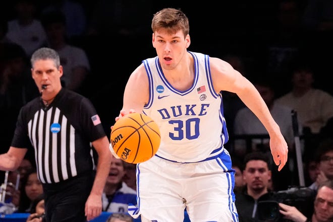 Mar 24, 2024; Brooklyn, NY, USA; Duke Blue Devils center Kyle Filipowski (30) dribbles the ball against the James Madison Dukes in the second round of the 2024 NCAA Tournament at Barclays Center. Mandatory Credit: Robert Deutsch-USA TODAY Sports