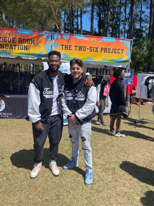 Two-Six Project founder Grant Bennett, left, and chief of staff Marc Somar, attend Dreamville Festival at Dorothea Dix Park in Raleigh on Saturday, April 2, 2022.