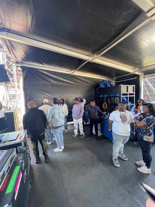 Fayetteville artist Morray (third from right in white shirt) prepares to go onstage at Dreamville Festival at Dorothea Dix Park in Raleigh on Saturday, April 2, 2022.