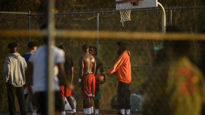 J. Cole talks to some of the actors on a basketball court near Walker-Spivey Elementary School on Thursday, Jan. 9, 2020.